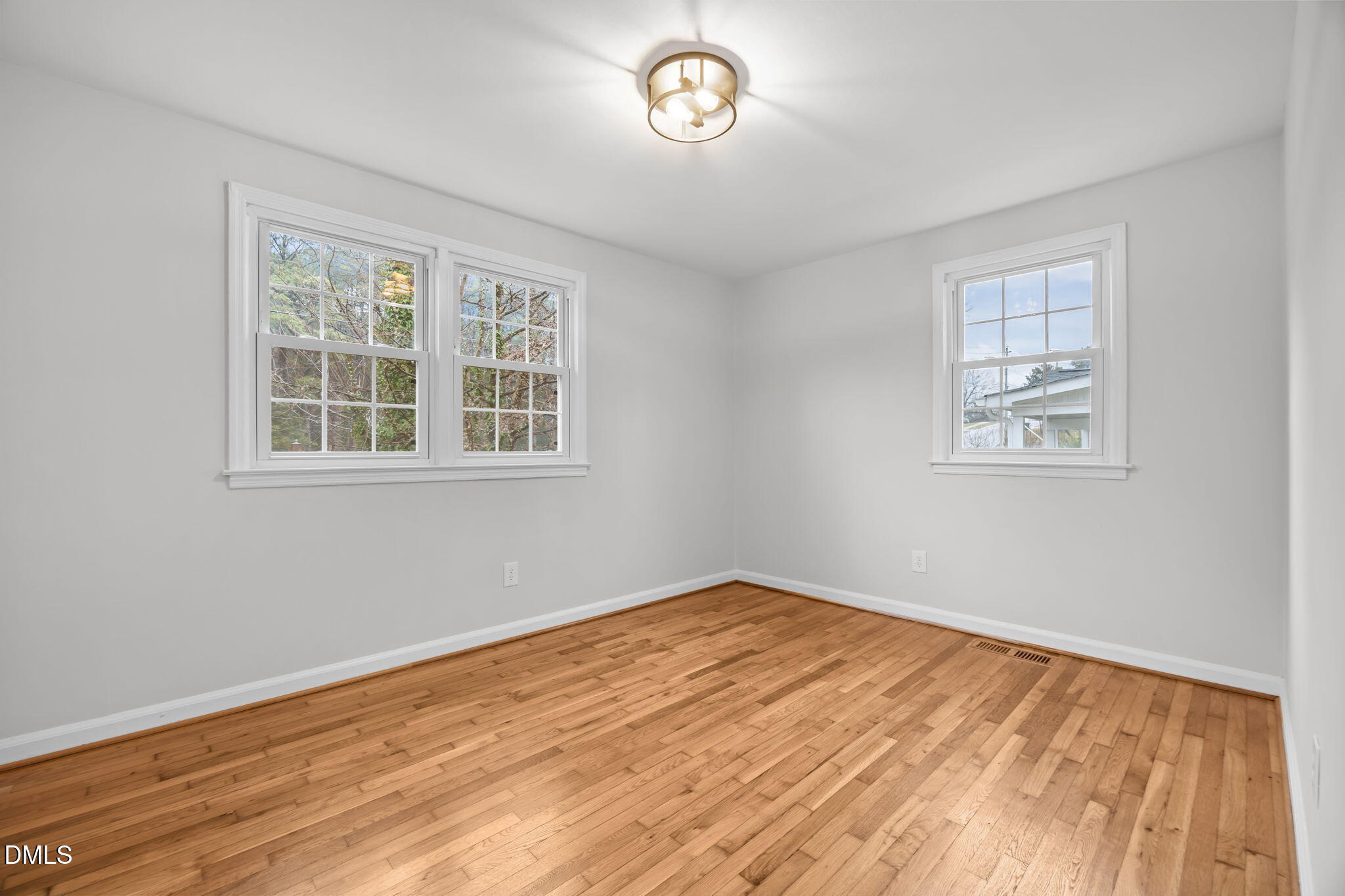 2239 Rumson Road Raleigh, NC 27610 - Photo 27 of 39 a view of empty room with wooden floor and fan