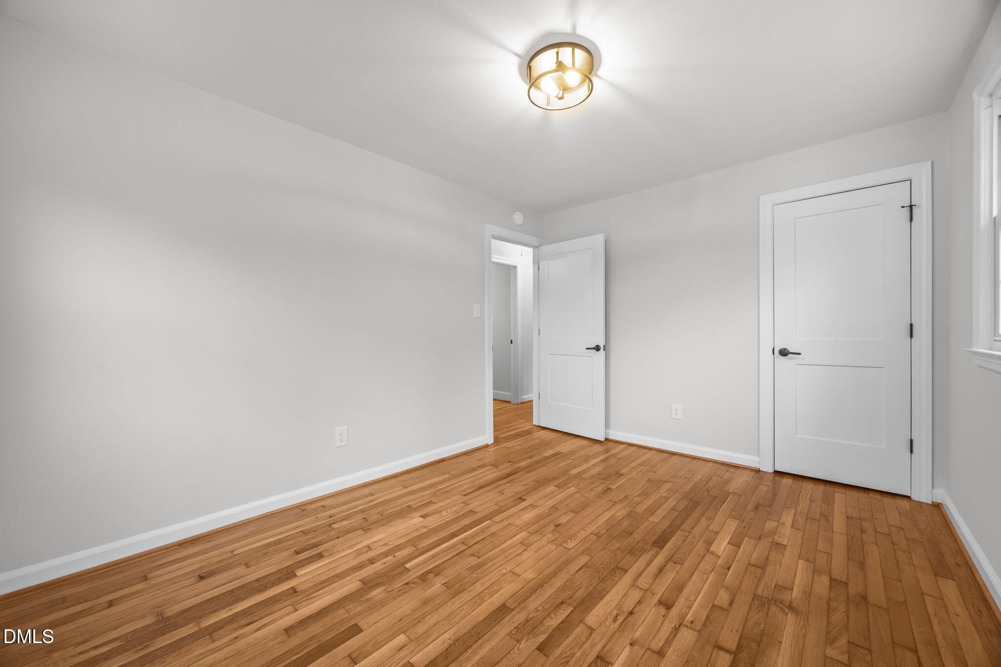 2239 Rumson Road Raleigh, NC 27610 - Photo 28 of 39 a view of empty room with wooden floor