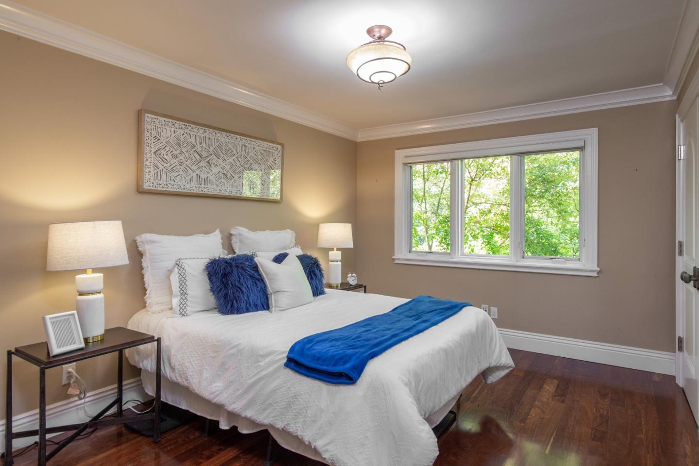 240 Laning Drive Woodside, CA 94062 - Photo 15 of 35 a bedroom with a bed and a lamp next to a window