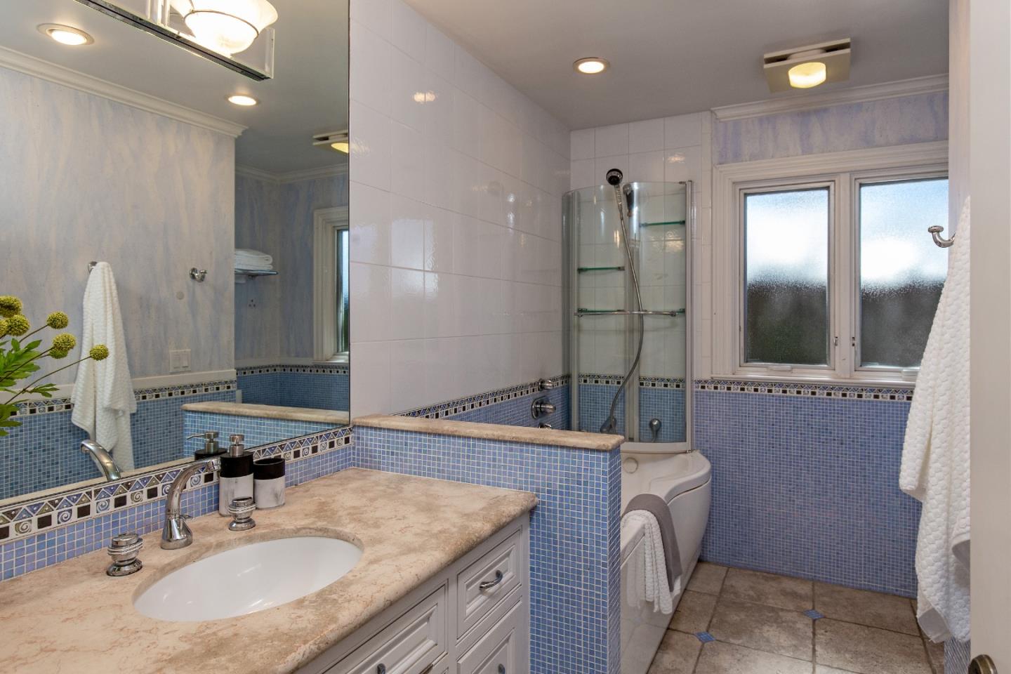 240 Laning Drive Woodside, CA 94062 - Photo 16 of 35 a bathroom with a granite countertop sink a shower and a mirror