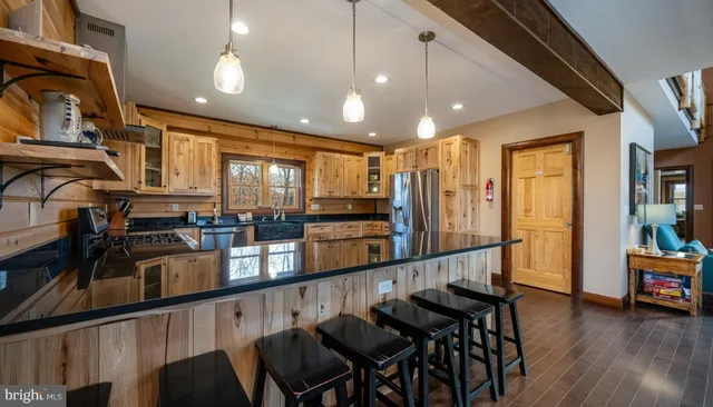 a bed sitting in a spacious bedroom next to a window