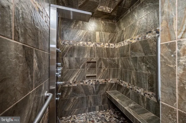 a bedroom with a bed a couch and a window