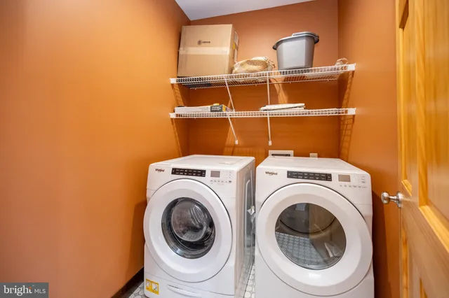 a bathroom with a granite countertop sink a mirror and shower