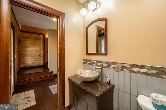 a kitchen with granite countertop white cabinets and wooden floor