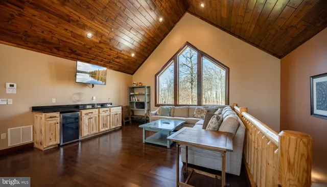 a living room with furniture rug and a table