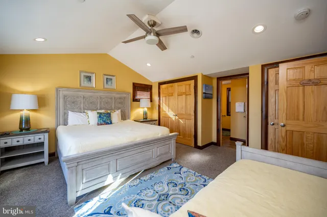 a bedroom with a large bed and a large window