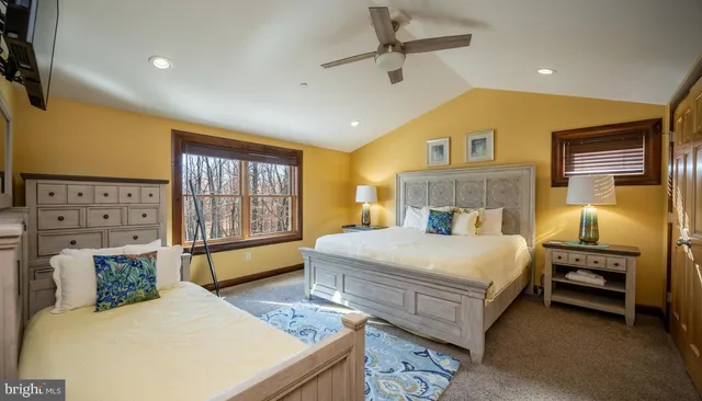 a bathroom with a tub shower vanity and a sink