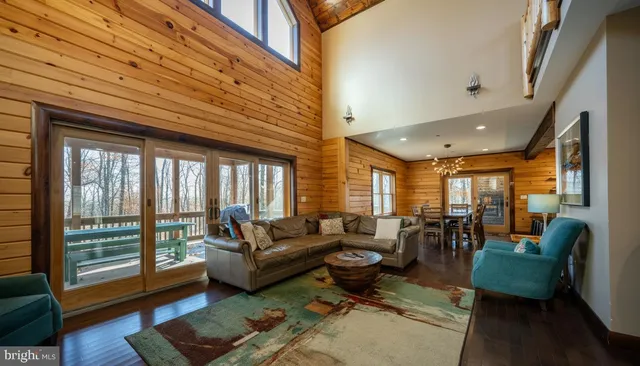 a view of a dining room with furniture and a chandelier
