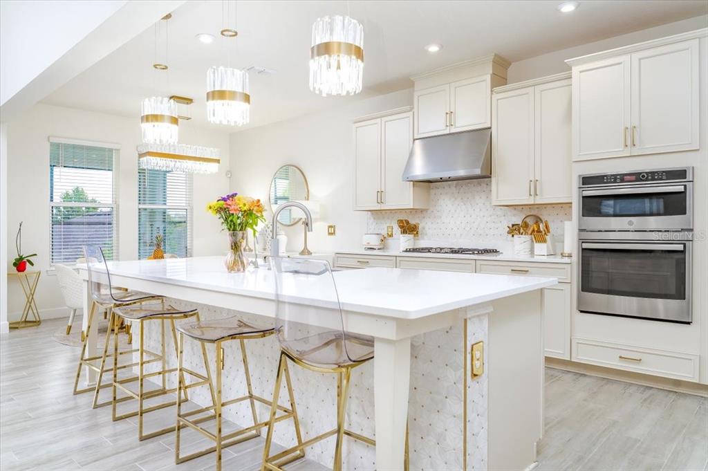 1296 Waterview Ridge Circle Apopka, FL 32703 - Photo 3 of 60 a kitchen with stainless steel appliances granite countertop a sink and a refrigerator
