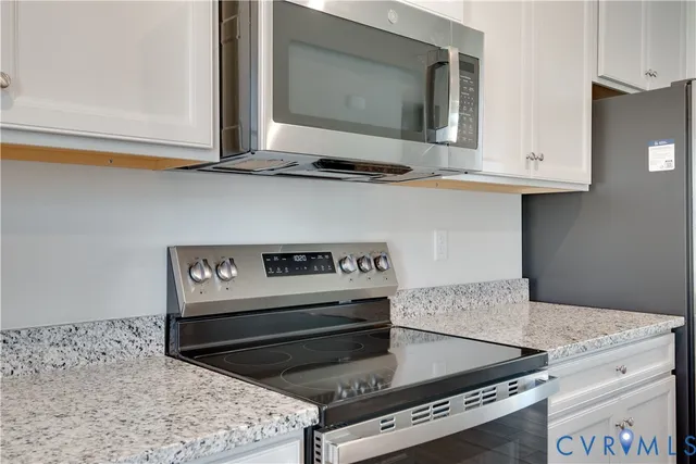 a kitchen with a stove and a microwave