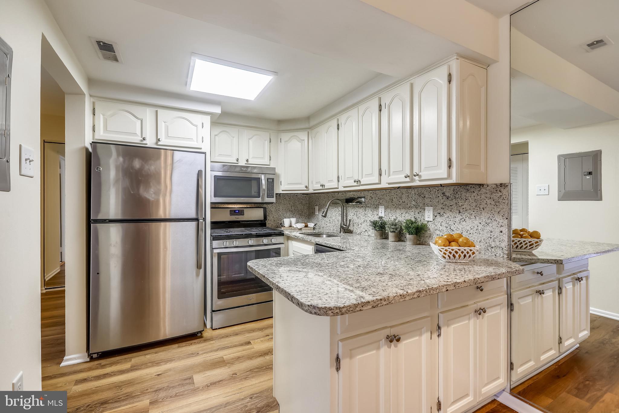 2572 Riva Road, Unit 9B Annapolis, MD 21401 - Photo 10 of 36 a kitchen with stainless steel appliances granite countertop a refrigerator sink and cabinets
