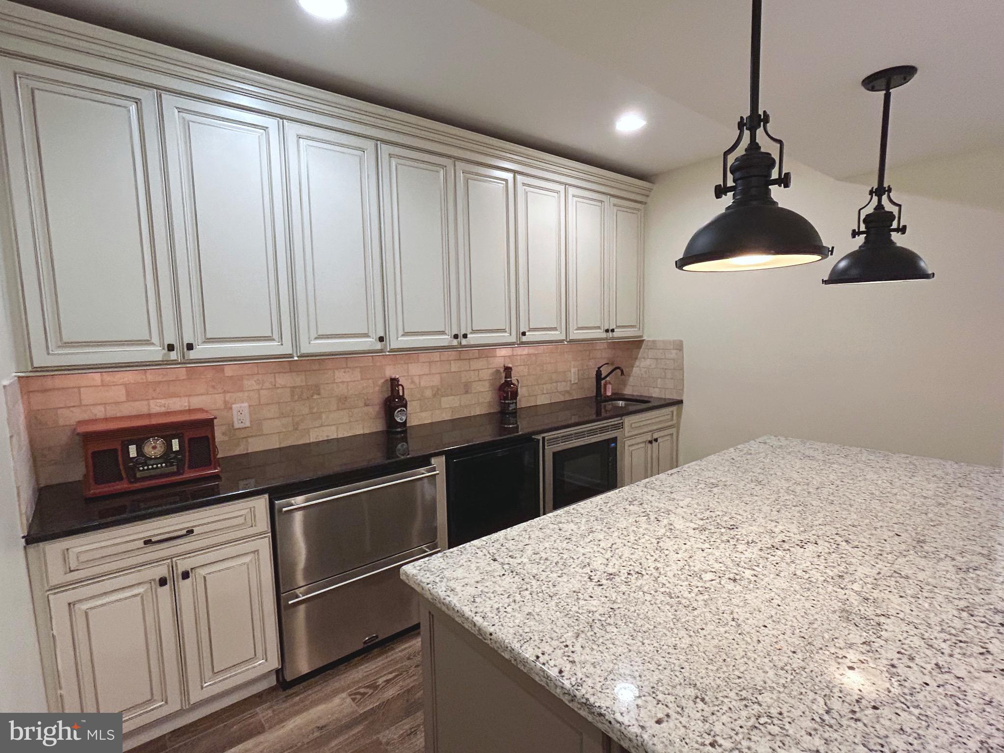25 Baldwin Circle Glenmoore, PA 19343 - Photo 25 of 33 a kitchen with granite countertop a sink and cabinets