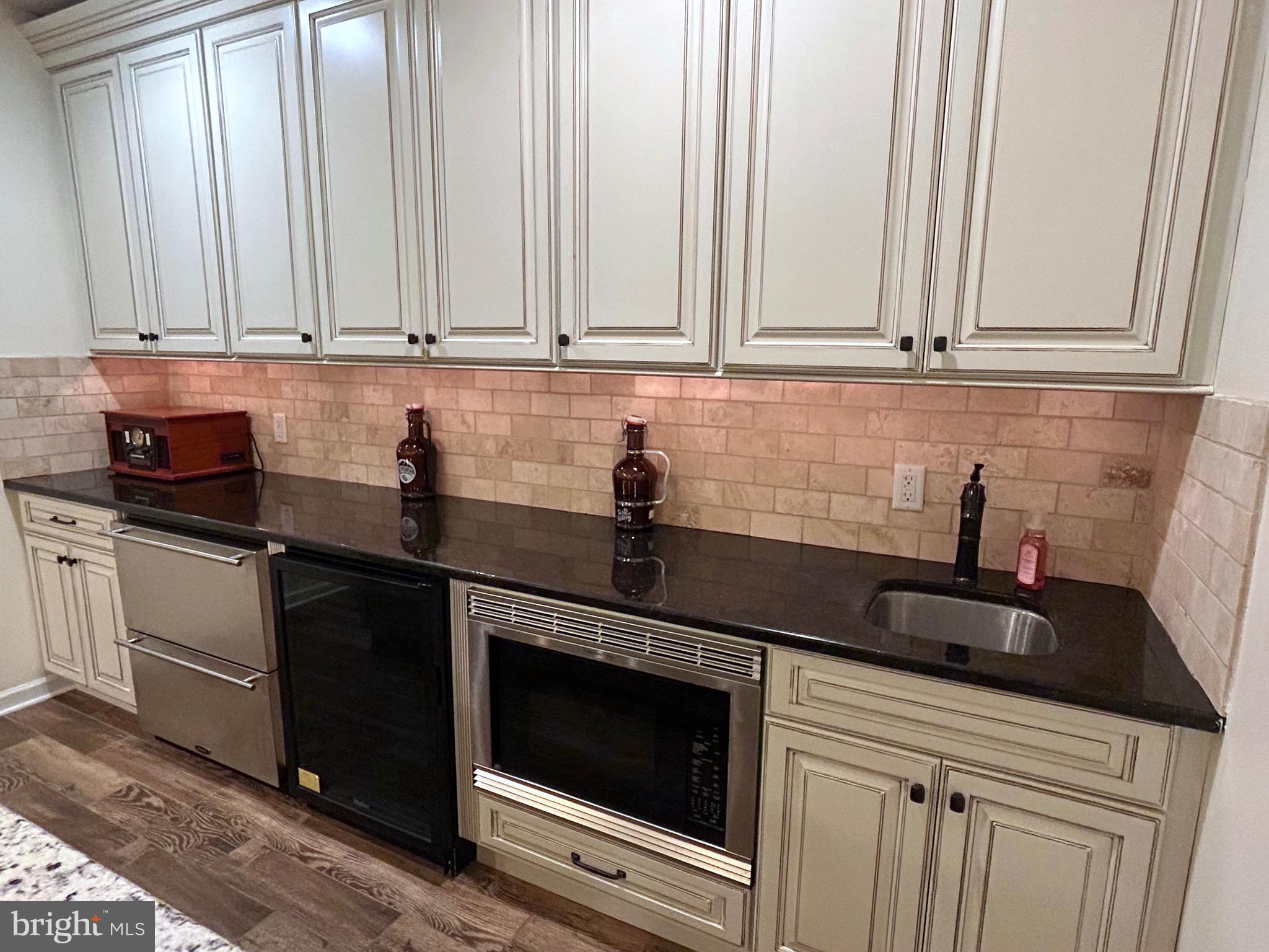 25 Baldwin Circle Glenmoore, PA 19343 - Photo 26 of 33 a kitchen with white cabinets and a sink