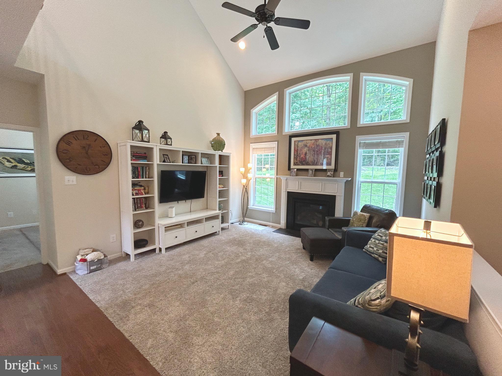 25 Baldwin Circle Glenmoore, PA 19343 - Photo 6 of 33 a living room with furniture a flat screen tv and a fireplace