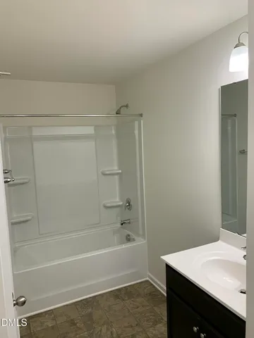 a bathroom with a bathtub and a sink