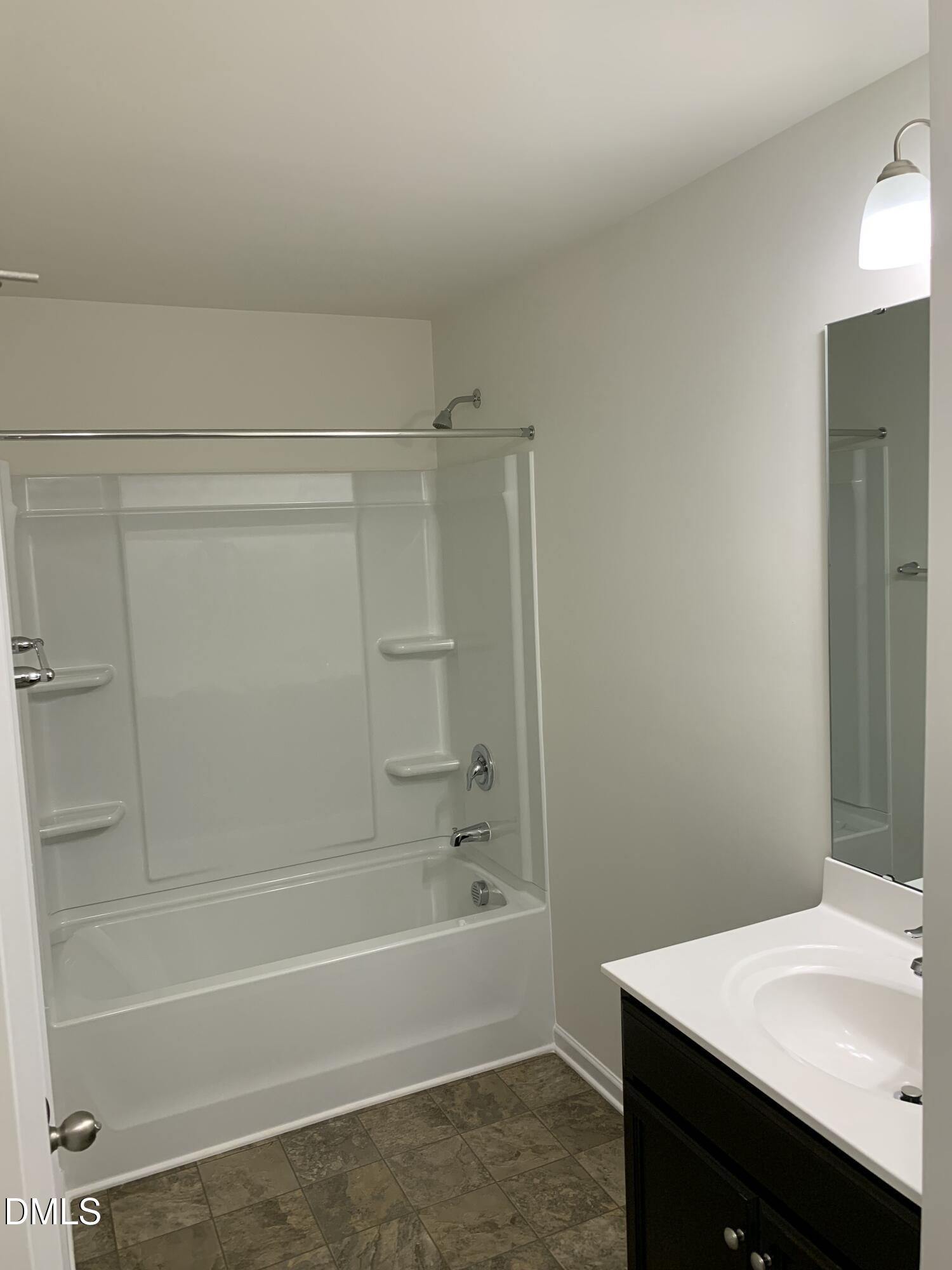 1249 Turkey Trot Road Wendell, NC 27591 - Photo 19 of 42 a bathroom with a bathtub and a sink