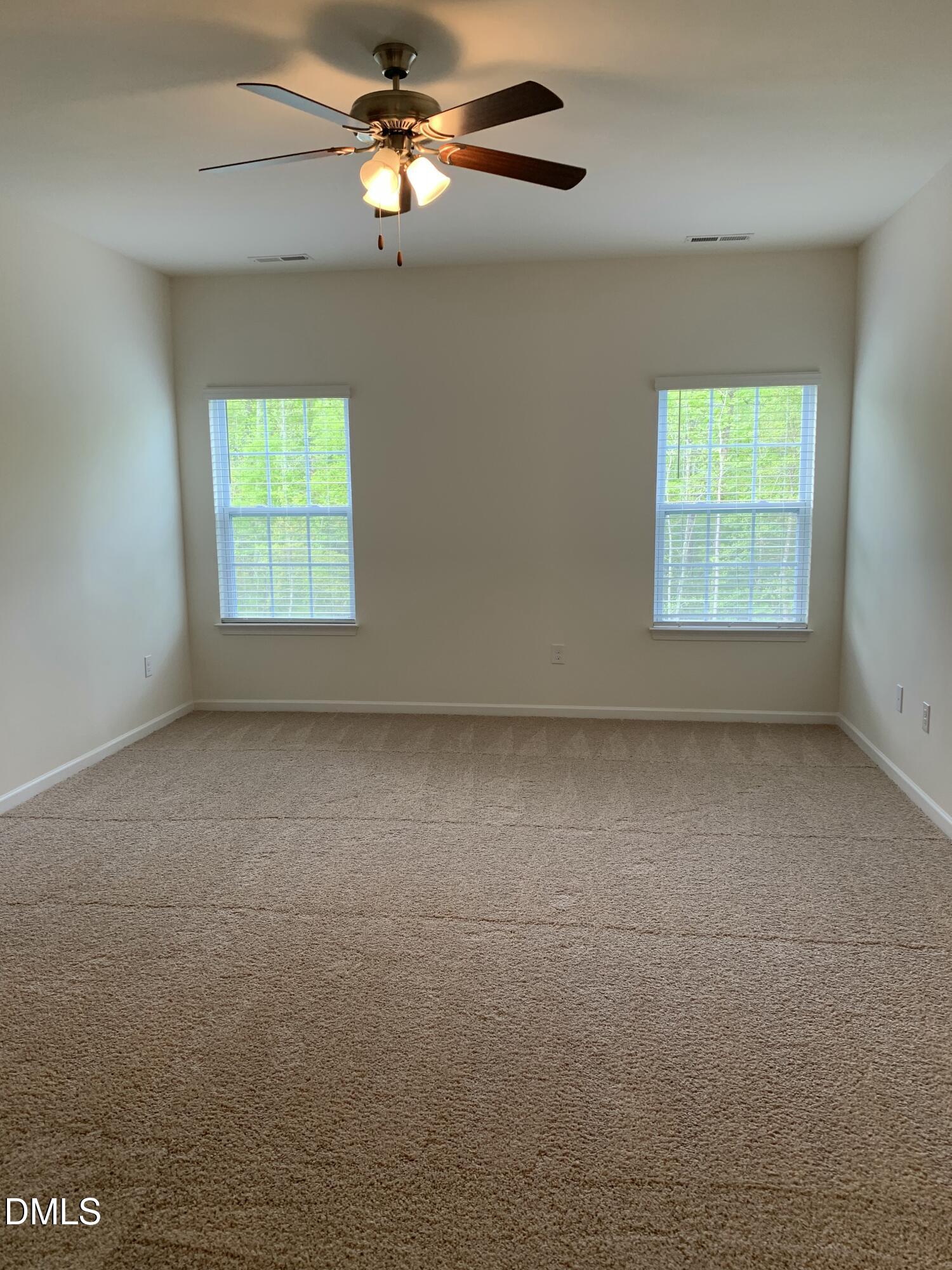 1249 Turkey Trot Road Wendell, NC 27591 - Photo 24 of 42 an empty room with a window and a fan