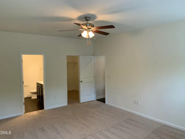 a view of a livingroom with a chandelier fan