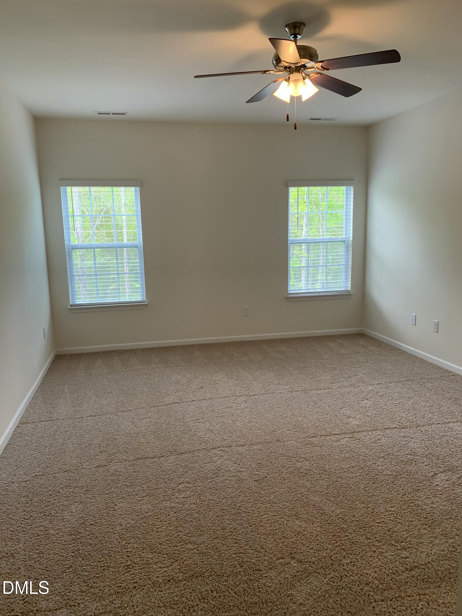 1249 Turkey Trot Road Wendell, NC 27591 - Photo 26 of 42 an empty room with a window and a fan