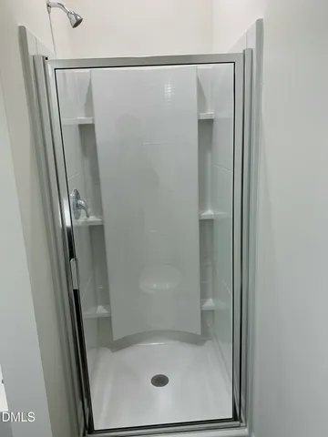 a bathroom with a glass shower door