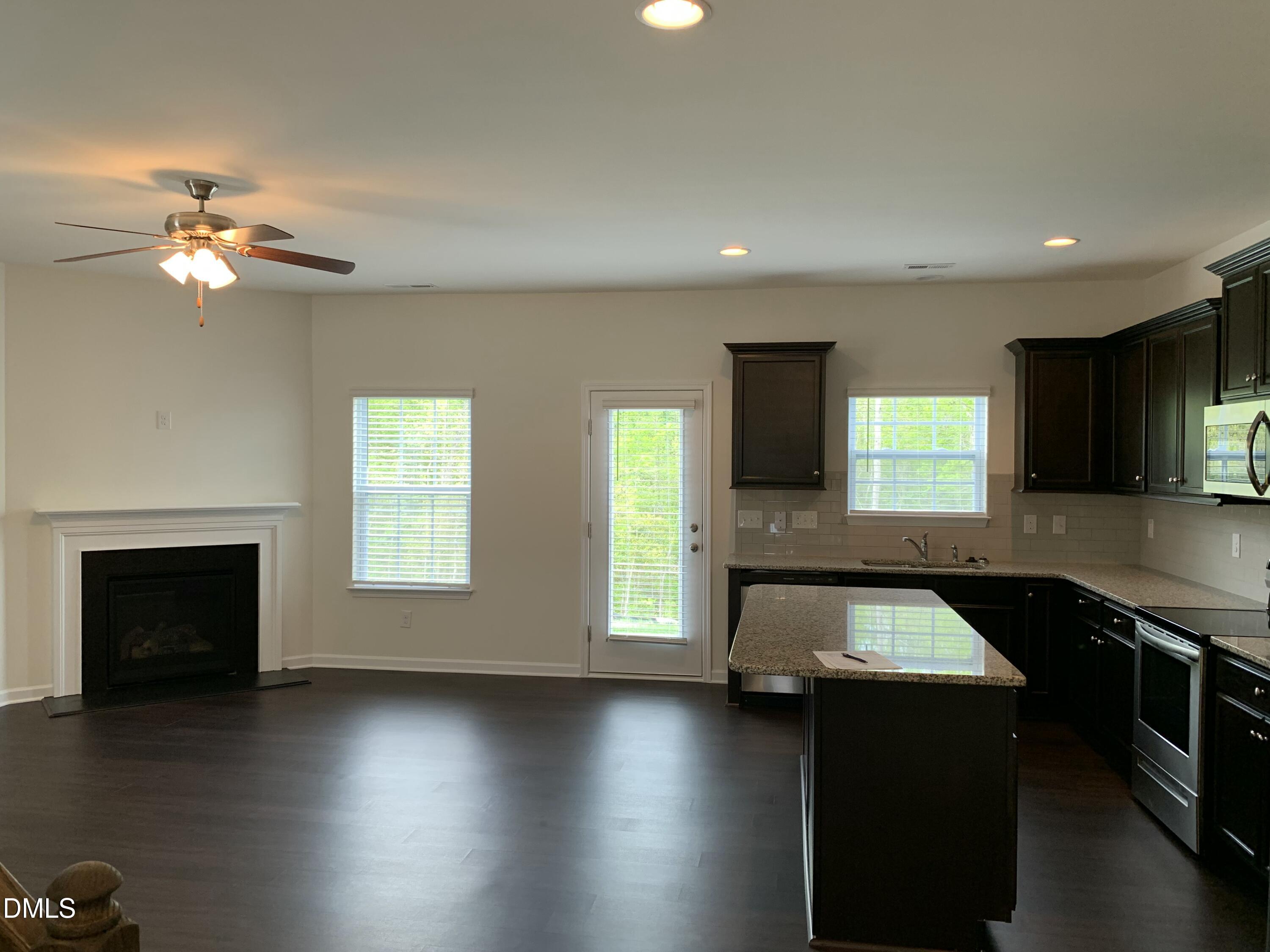 1249 Turkey Trot Road Wendell, NC 27591 - Photo 2 of 42 a kitchen with a stove and a wooden floor