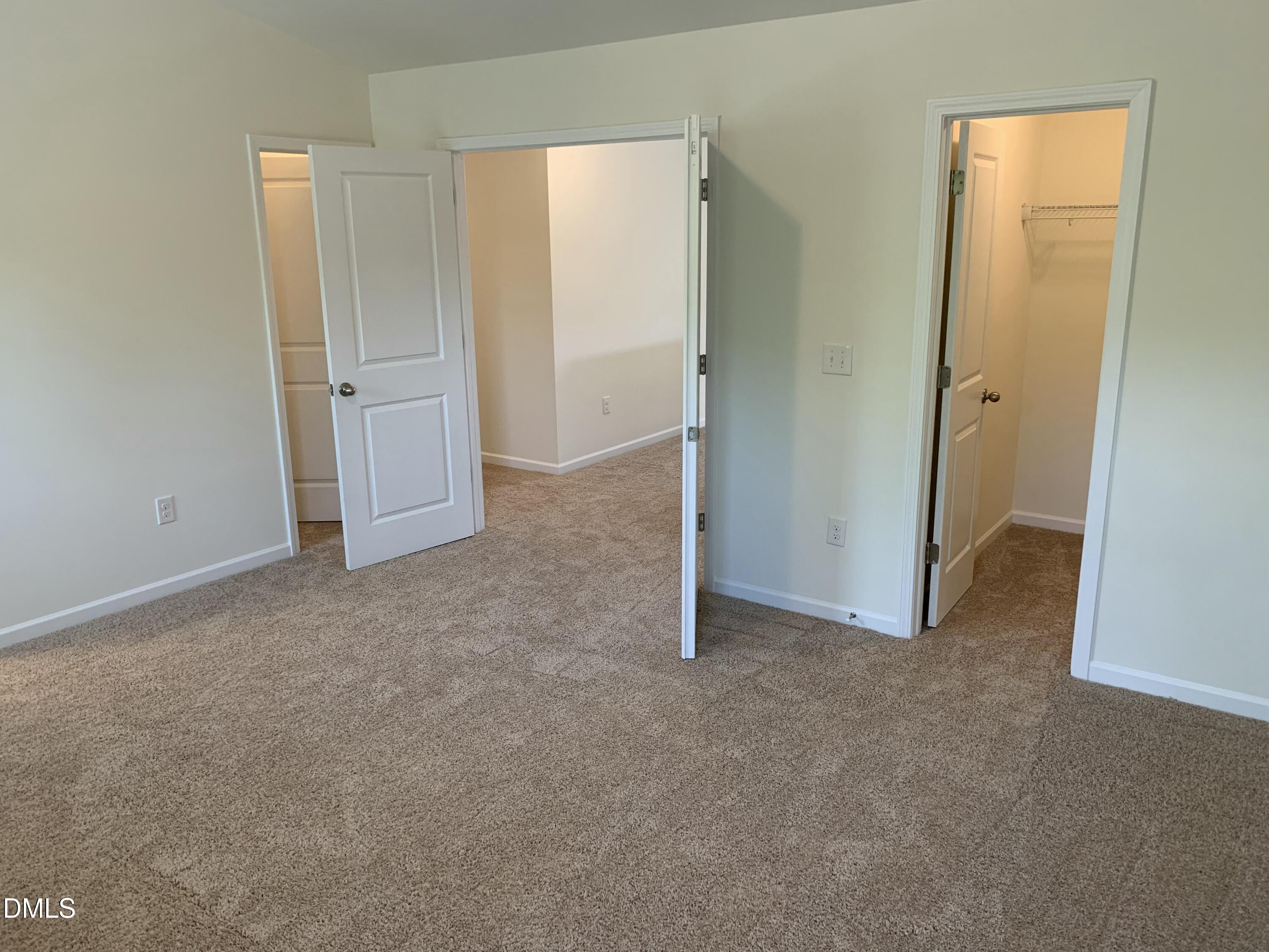 1249 Turkey Trot Road Wendell, NC 27591 - Photo 31 of 42 an empty room with closet and mirror