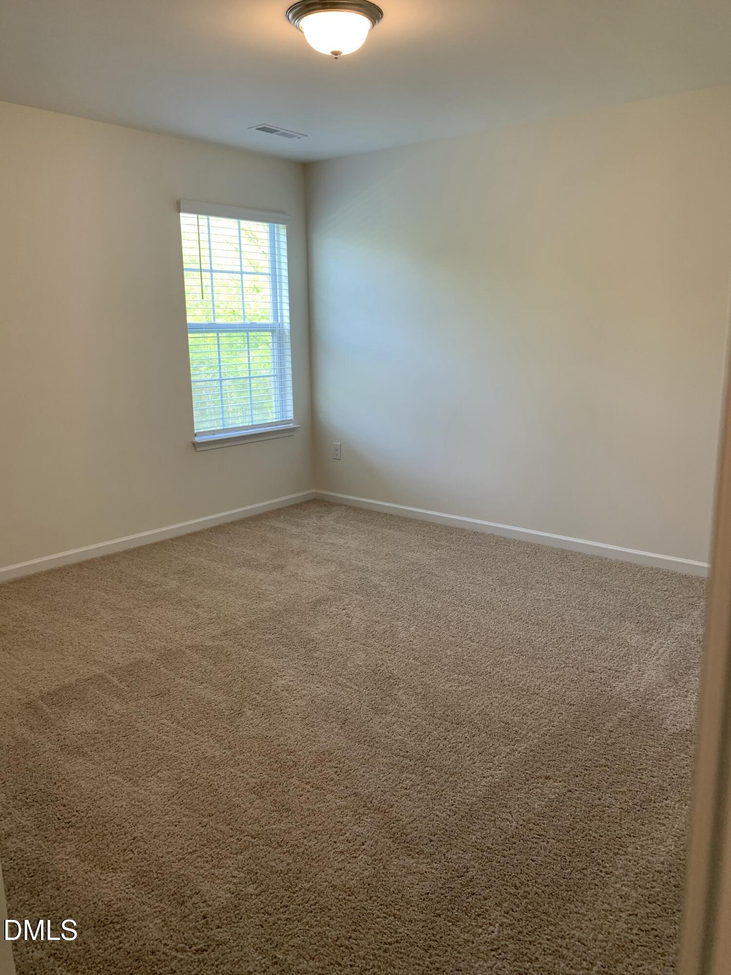 1249 Turkey Trot Road Wendell, NC 27591 - Photo 33 of 42 an empty room with windows