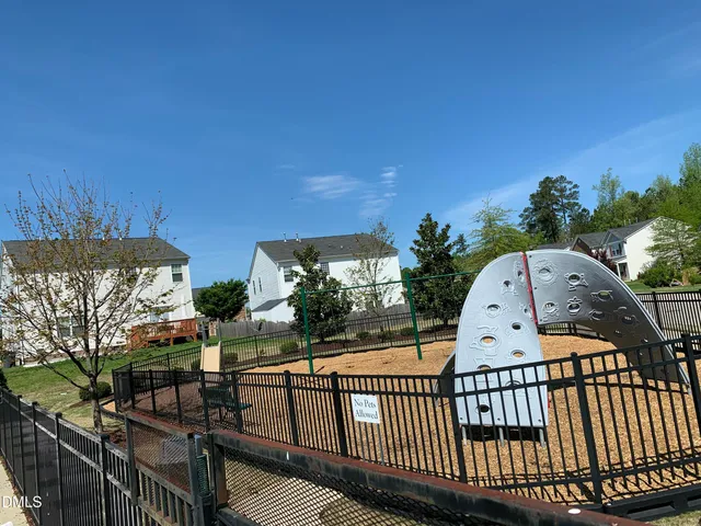 a view of a brick house with wooden fence