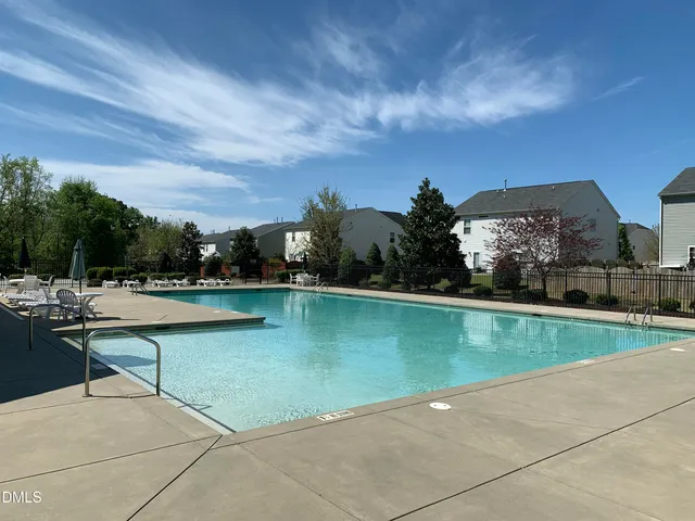 a view of a swimming pool and outdoor seating