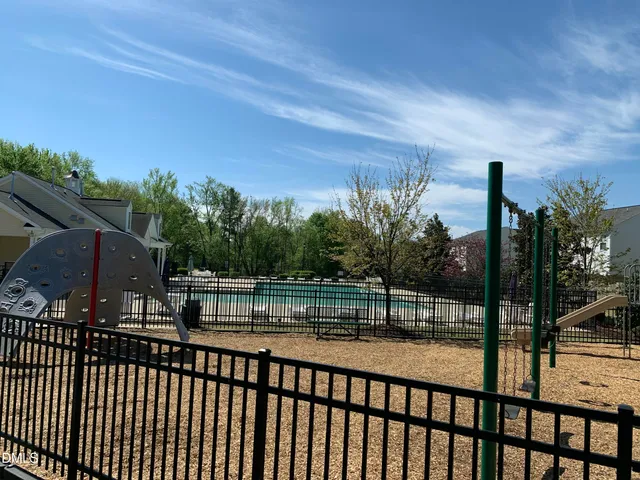 a view of a balcony with a floor to ceiling window and wooden fence
