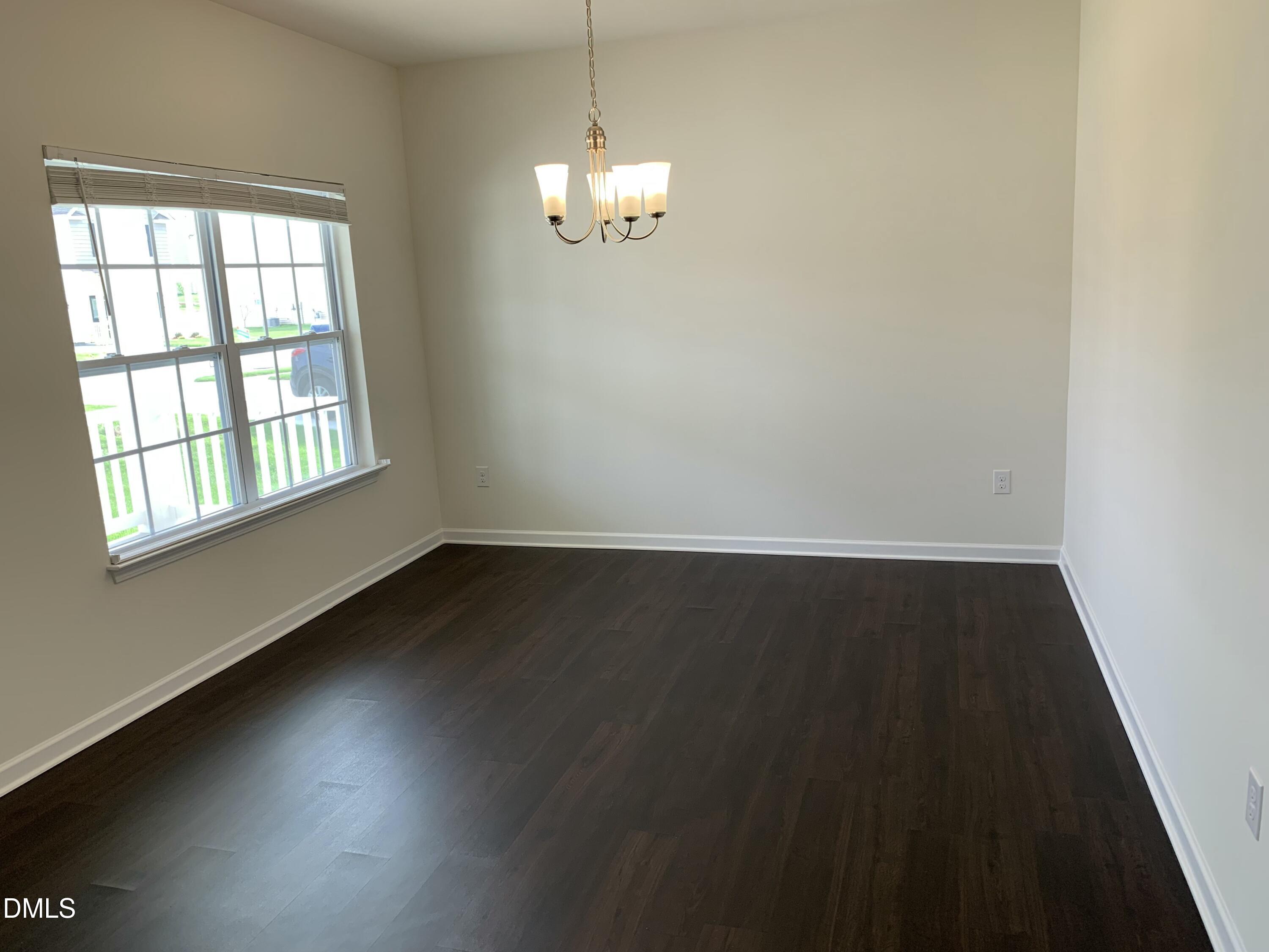 1249 Turkey Trot Road Wendell, NC 27591 - Photo 6 of 42 an empty room with wooden floor and windows