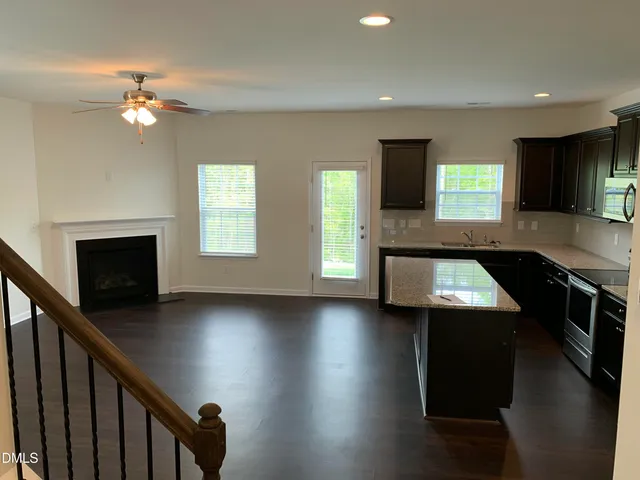 a kitchen with kitchen island a counter space a sink and appliances