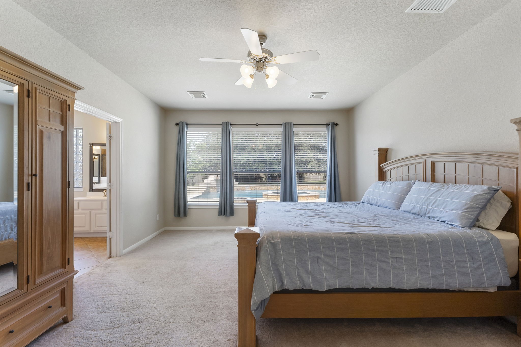 19223 Senterra Lakes Boulevard Spring, TX 77379 - Photo 15 of 48 a bedroom with a large bed and a large window