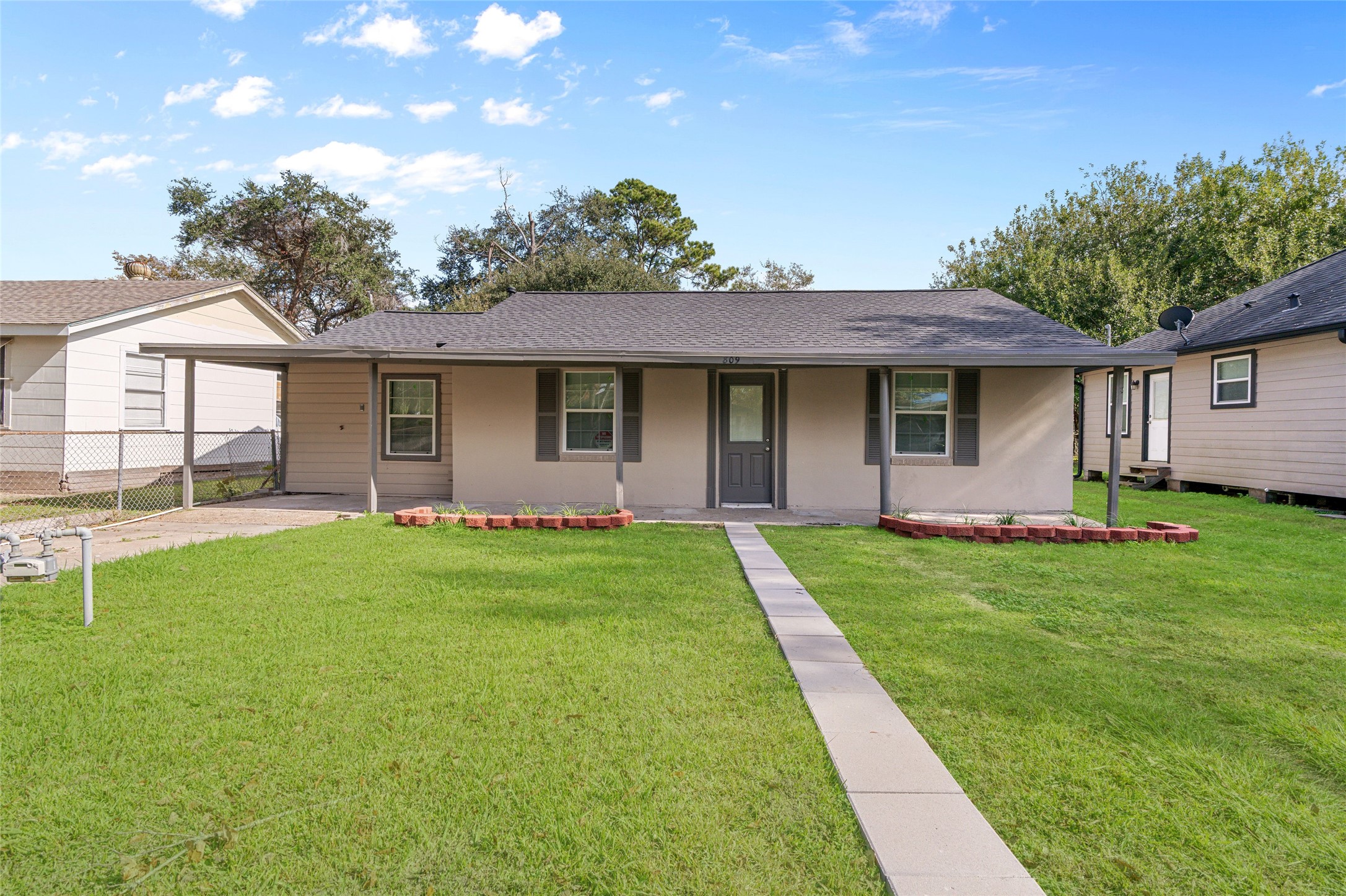 a front view of house with yard and green space