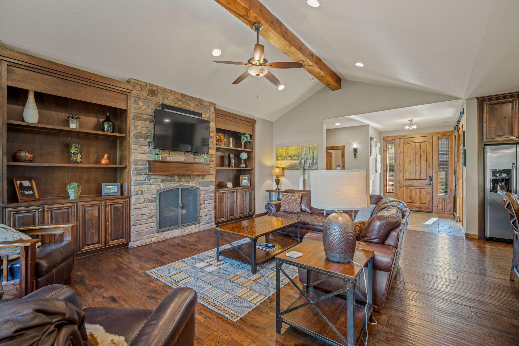 56508 Dancing Rock Loop, Unit 22 Bend, OR 97707 - Photo 14 of 69 a living room with furniture a flat screen tv and a fireplace