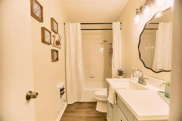 a bathroom with a sink mirror and a toilet