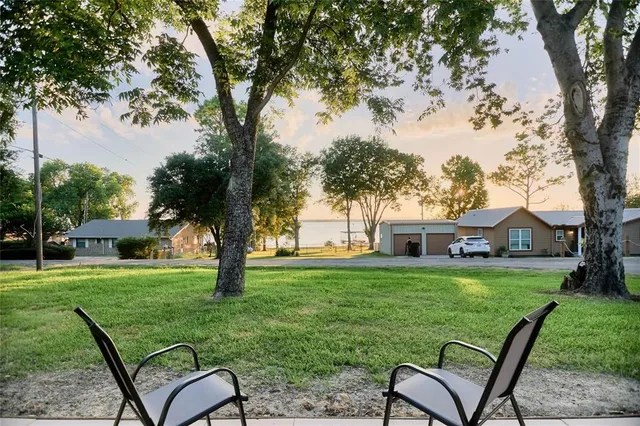 a view of a house with backyard sitting area and garden