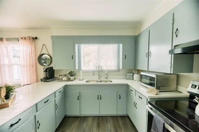 a kitchen with a sink stove and cabinets