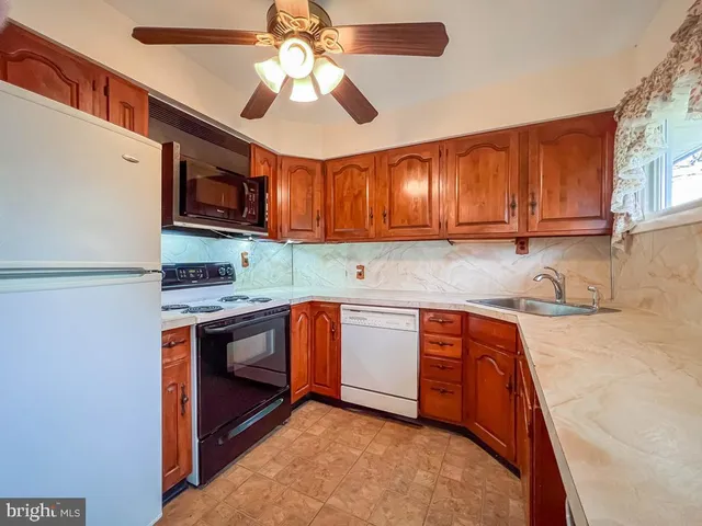 a kitchen with stainless steel appliances granite countertop a stove sink and microwave