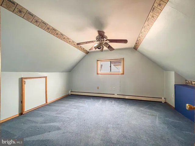 an empty room with a ceiling fan and a window
