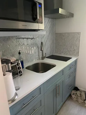 a kitchen with a sink and cabinets
