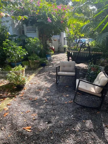 a view of a backyard with sitting area