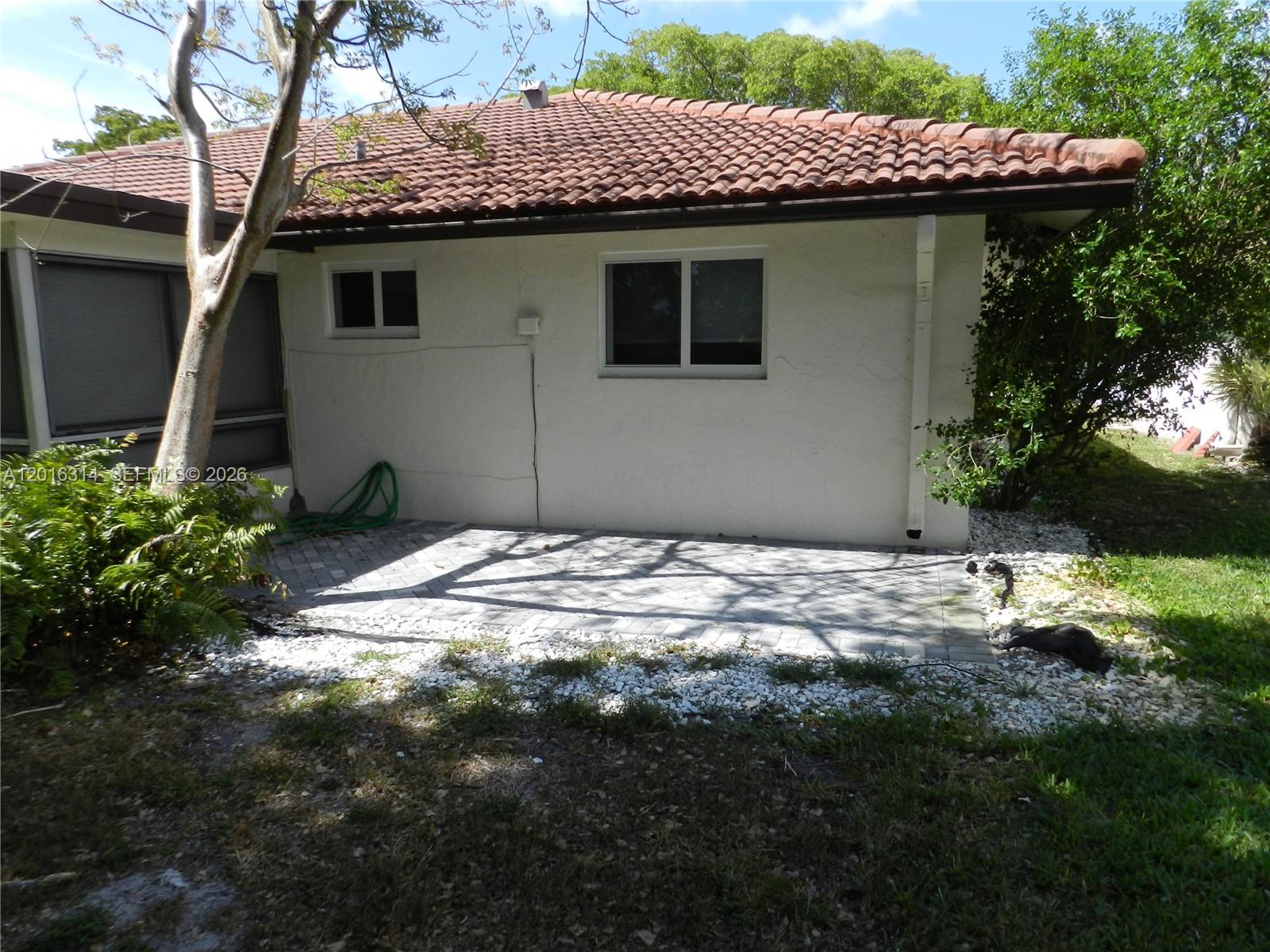 305 Northwest 42nd Street Boca Raton, FL 33431 - Photo 23 of 31 a view of a house with a small yard
