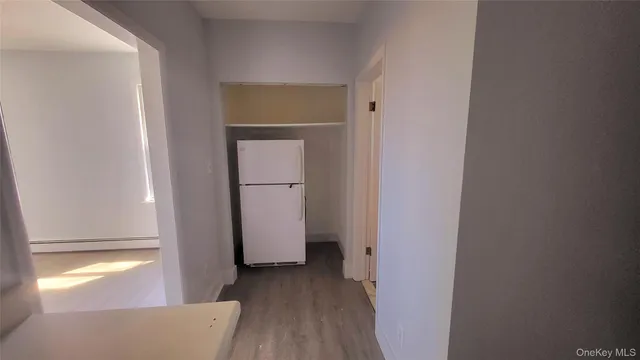 a view of a room that has a door and a window