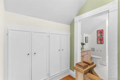 a bathroom with a granite countertop sink a toilet and a large mirror