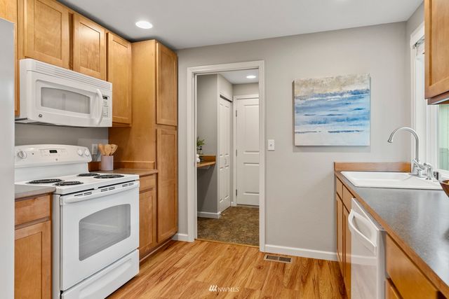 a kitchen with a stove a sink and a refrigerator