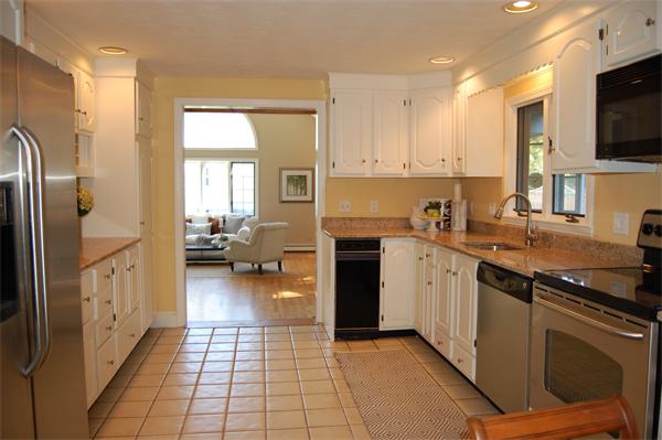 8 Scenna Road Beverly, MA 01915 - Photo 4 of 17 a kitchen with a sink a counter top space and stainless steel appliances