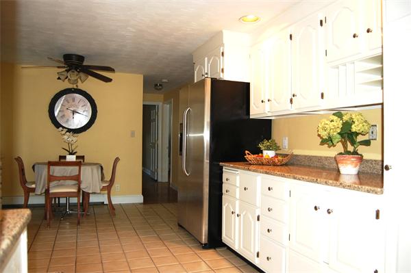 8 Scenna Road Beverly, MA 01915 - Photo 5 of 17 a kitchen with stainless steel appliances granite countertop a sink and a refrigerator