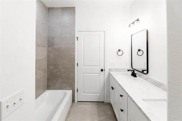 a bathroom with a double vanity sink a mirror and a shower