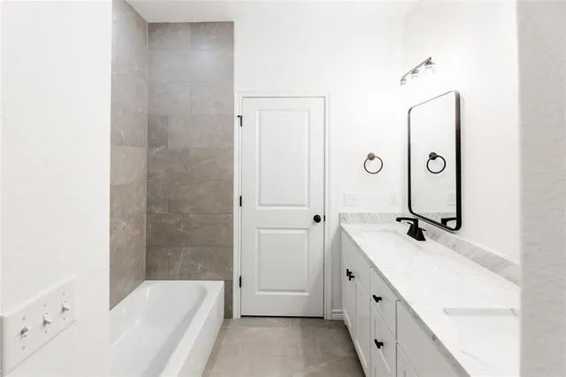 a bathroom with a double vanity sink a mirror and a shower